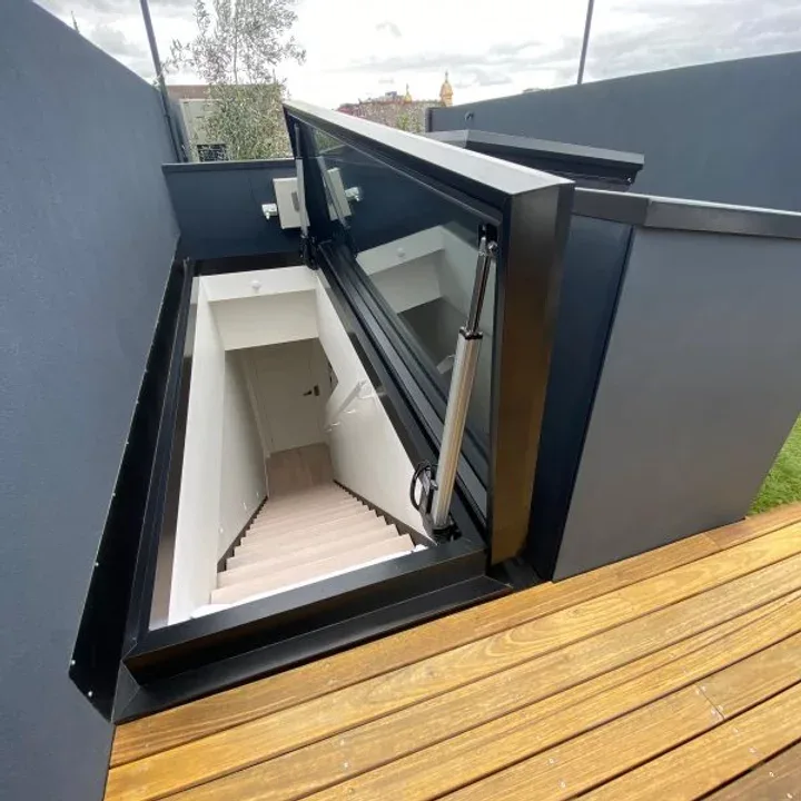 Open glazed roof access hatch above an internal stairway